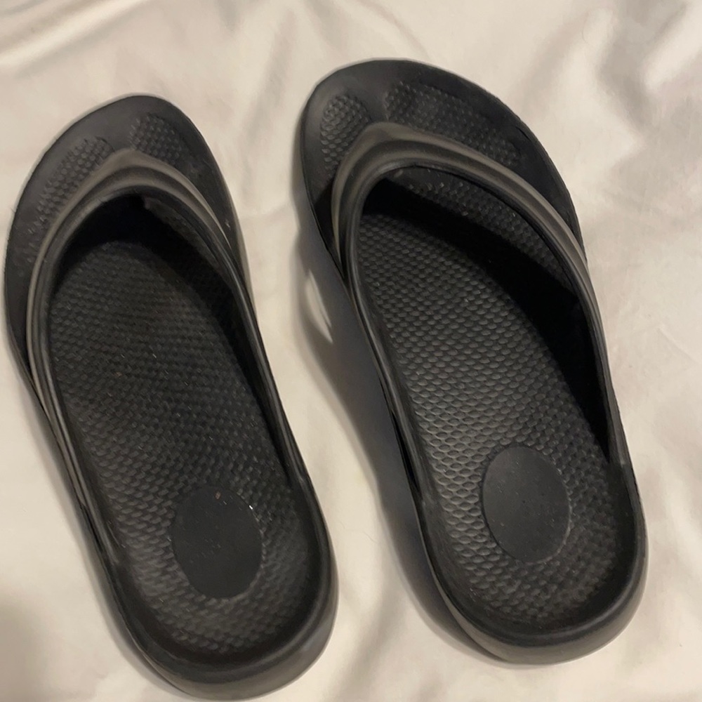 Black rubber flip flops